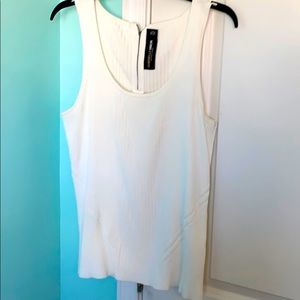 White sleeveless shirt.